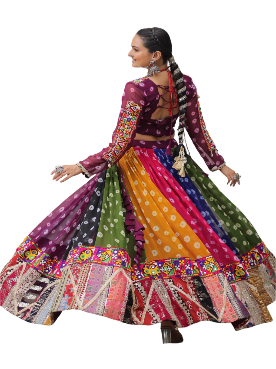 Woman in a colorful traditional outfit standing in an architectural setting.