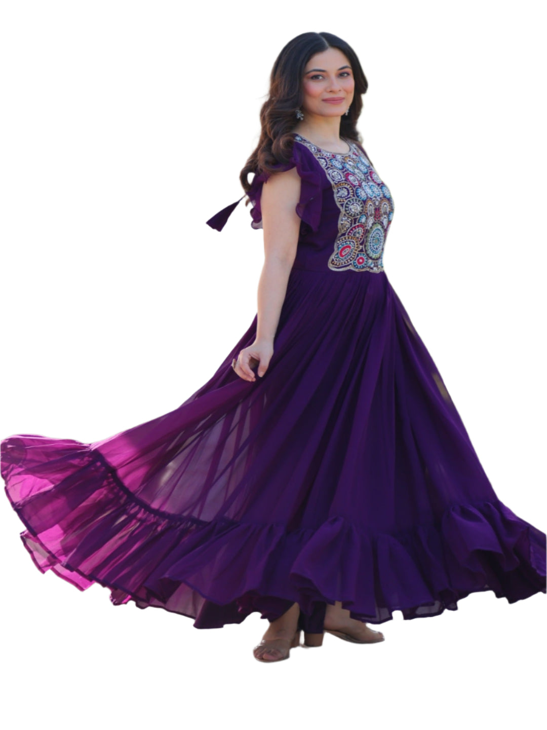 Woman in a purple dress with floral top standing outdoors.
