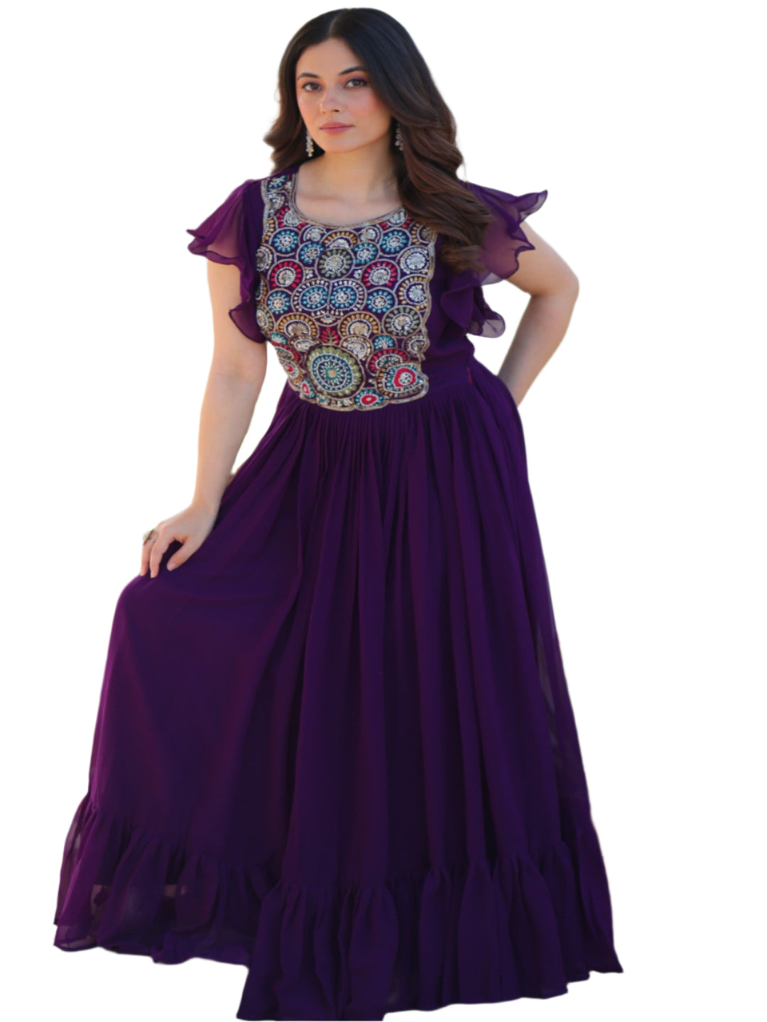 Woman in a purple dress with a floral top standing outdoors.