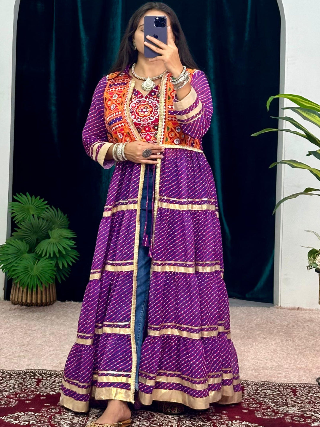 Person wearing a colorful traditional outfit in a room with decorative elements.
