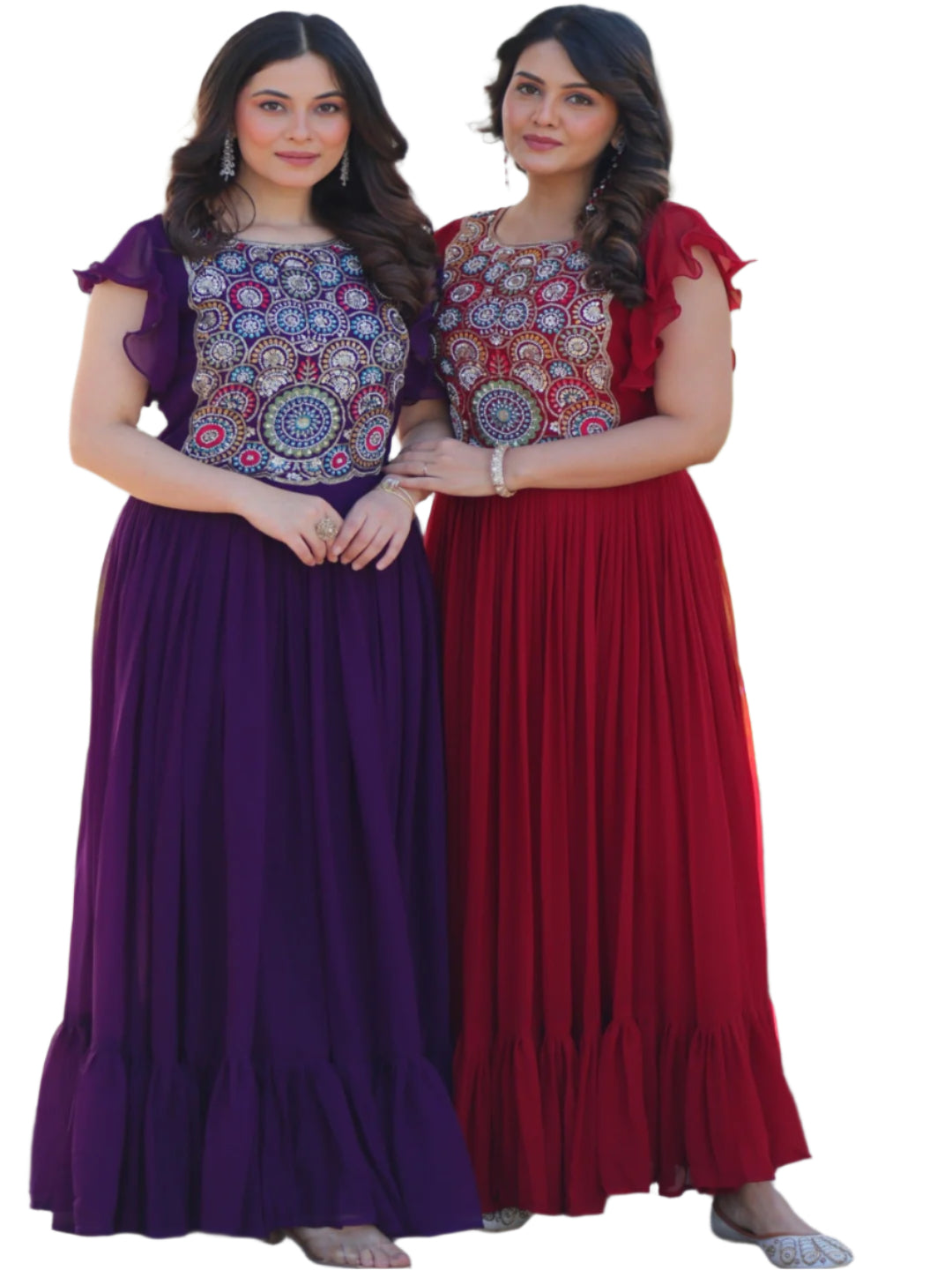 Two women in colorful traditional dresses standing outdoors with a garden background.