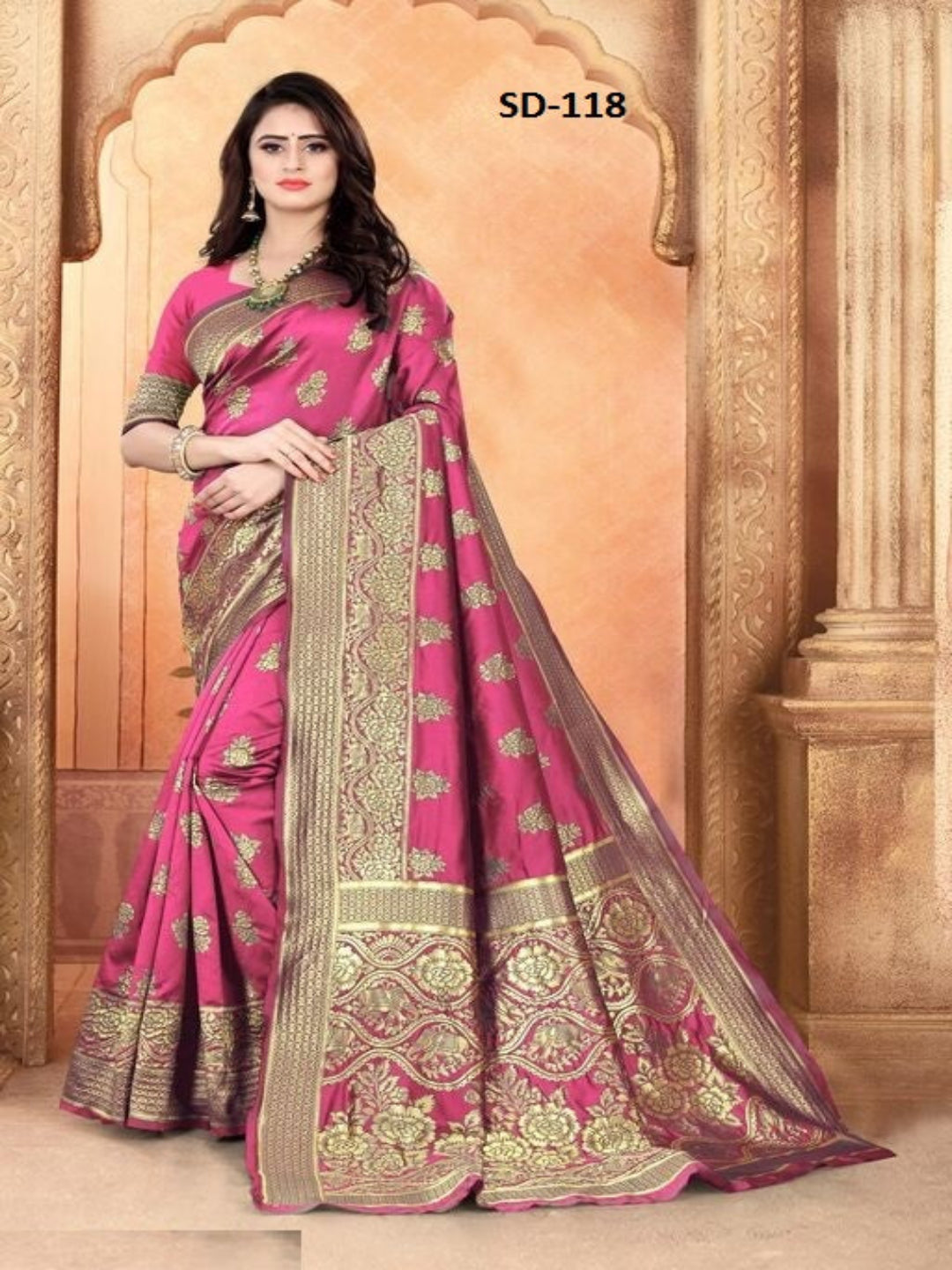 Woman wearing a pink saree with gold embroidery in an ornate setting