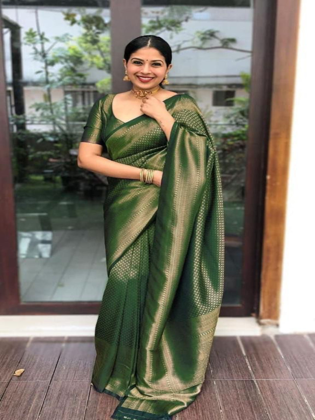 Woman wearing a green saree with a blurred background