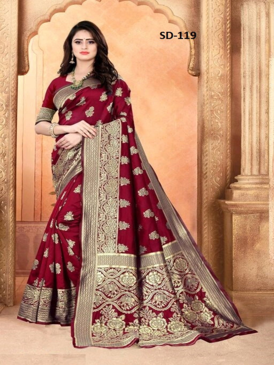 Maroon saree with gold embroidery on a decorative background