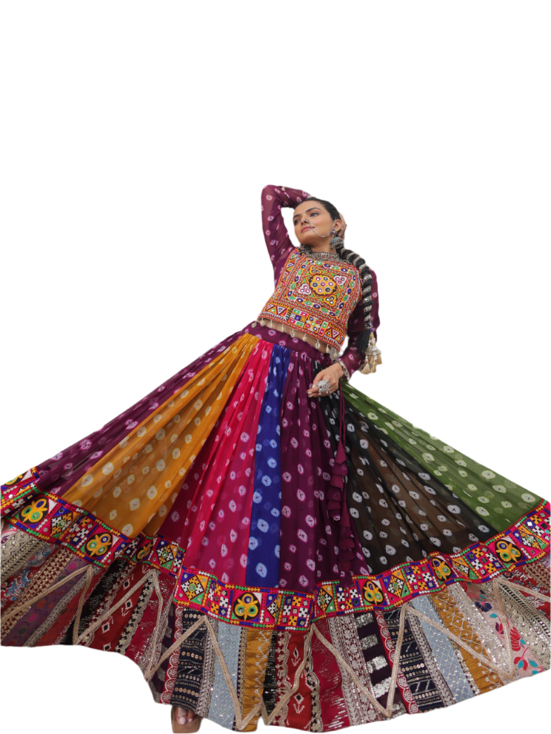 Woman in a colorful traditional outfit standing in front of a white wall with a window.