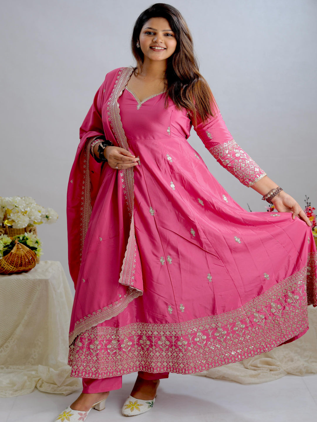 Woman in a pink traditional outfit with a white background