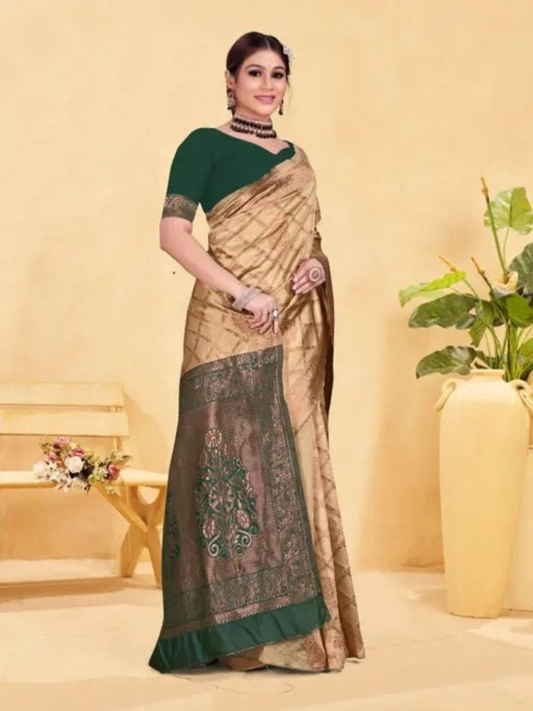 Woman wearing a traditional saree with a green blouse against a beige background