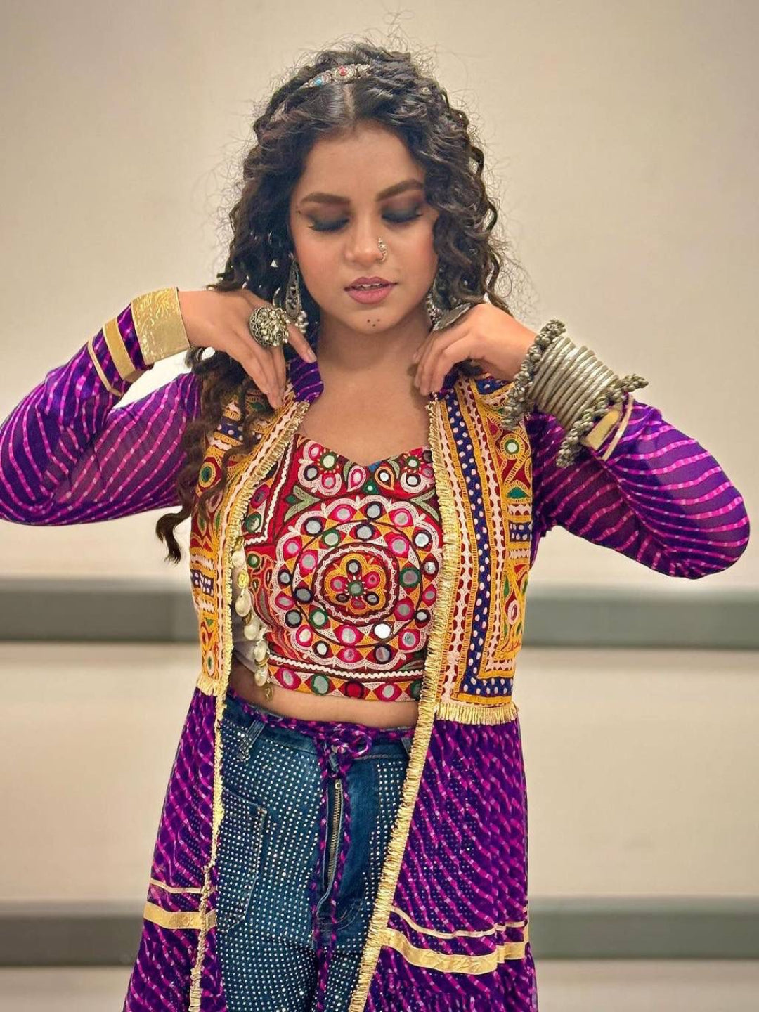 Woman wearing a colorful traditional outfit with intricate designs.