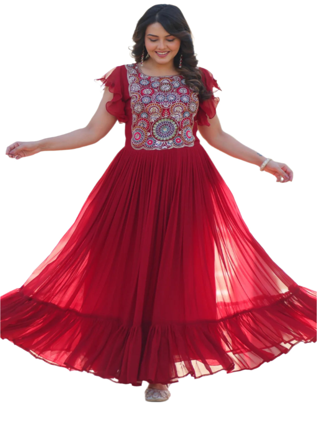 Woman in a red dress with floral patterns standing in front of an ornate architectural background.