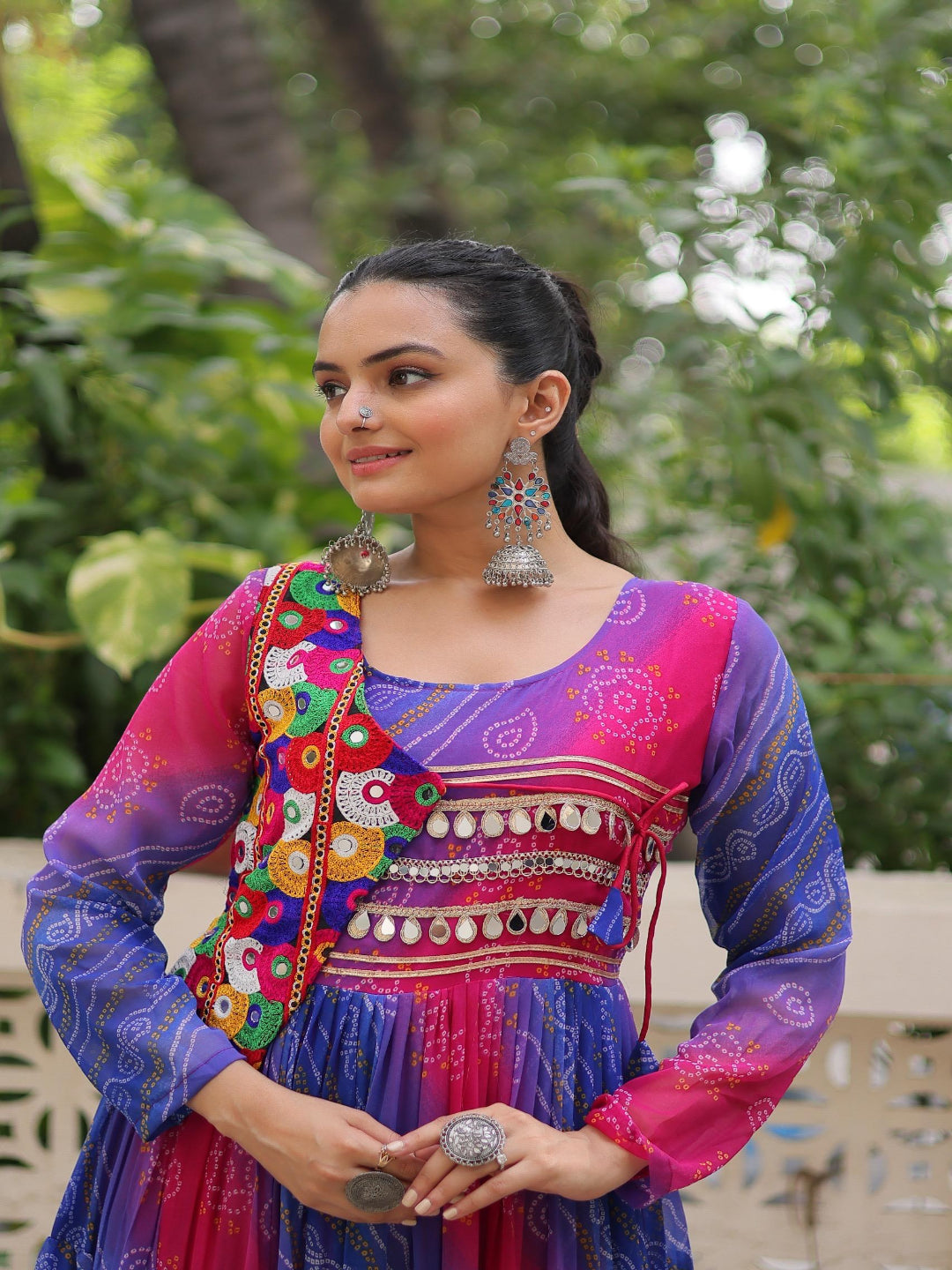 Woman in a colorful traditional outfit with a vibrant background
