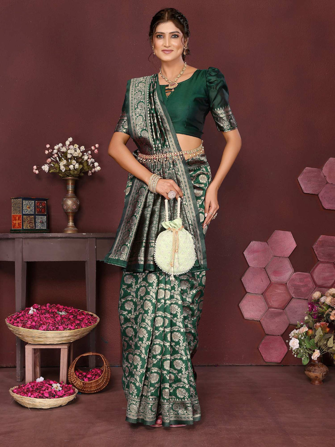 Woman in a green saree with a floral background