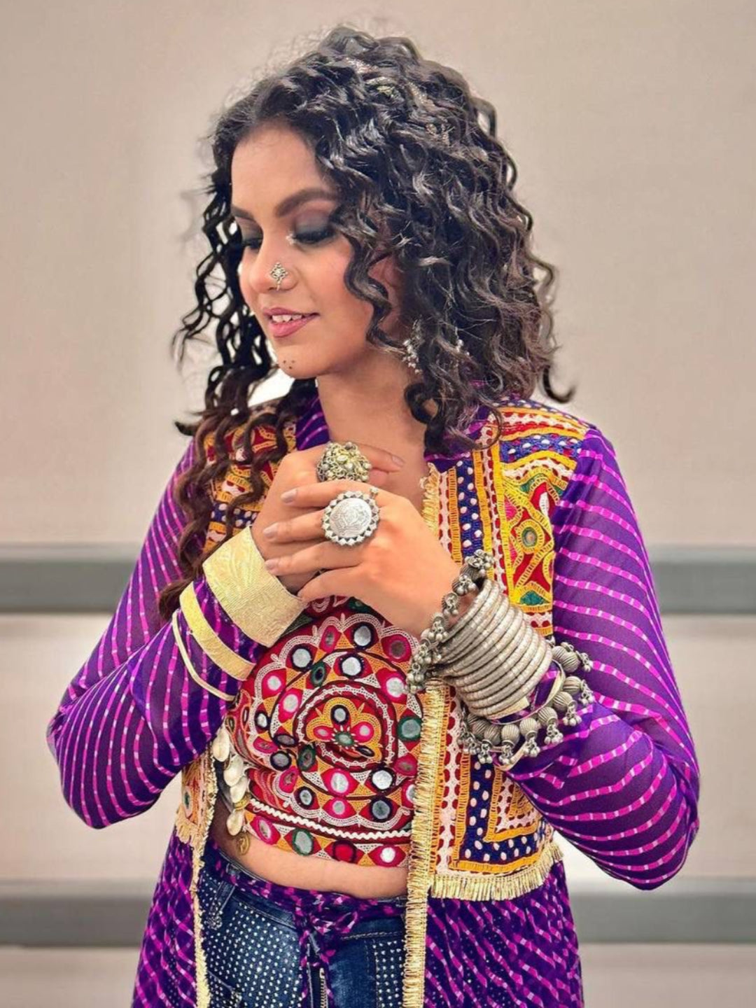 Woman wearing a colorful traditional outfit with intricate designs.