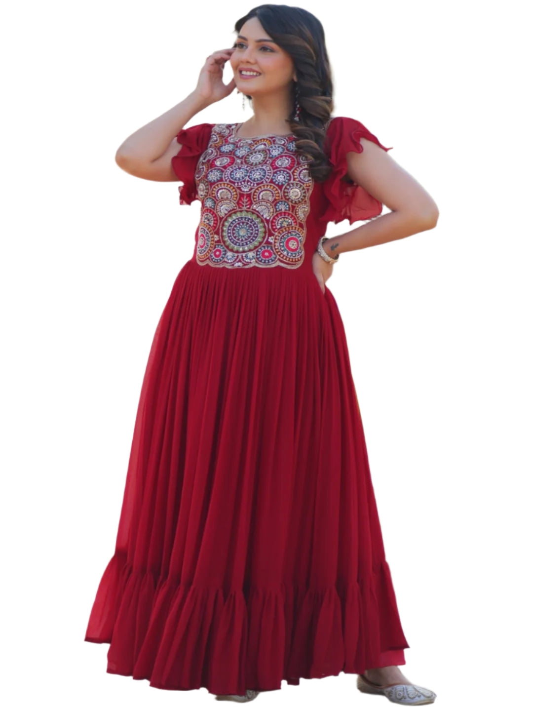 Woman in a red traditional outfit with floral patterns standing outdoors.