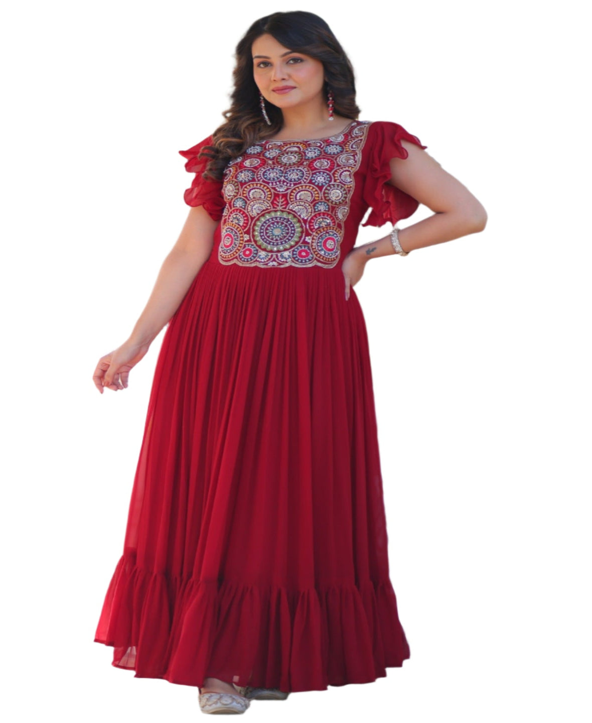 Woman in a red dress standing in front of a decorative archway with plants around.