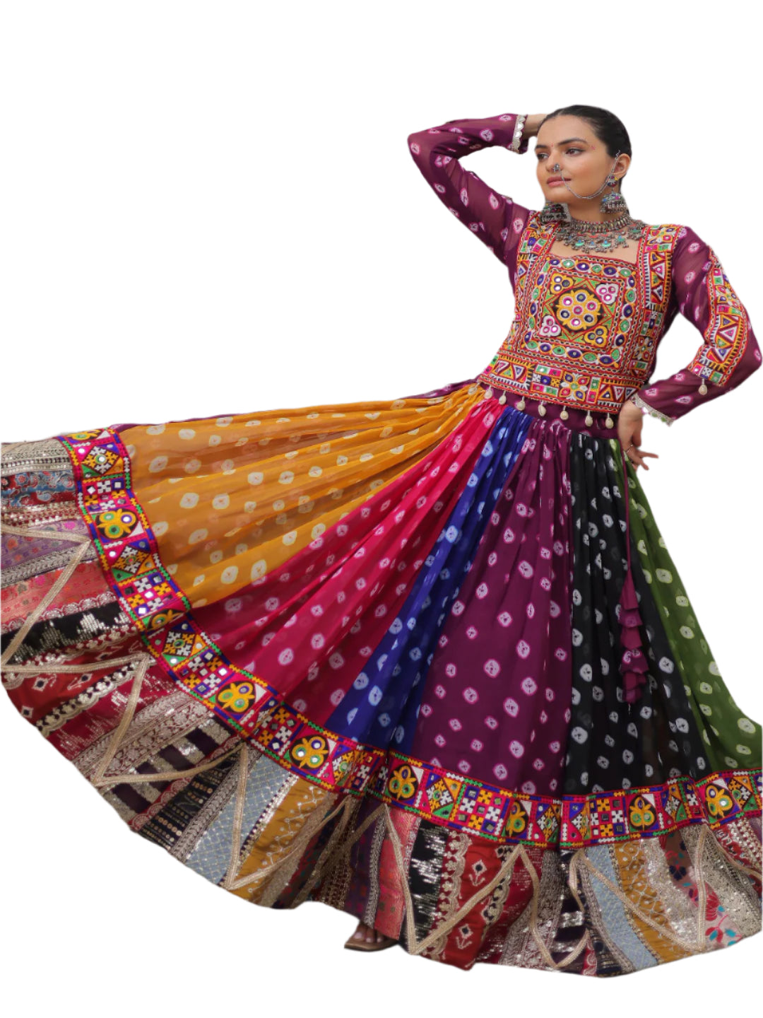 Woman in a colorful traditional outfit standing against a white wall with a window.