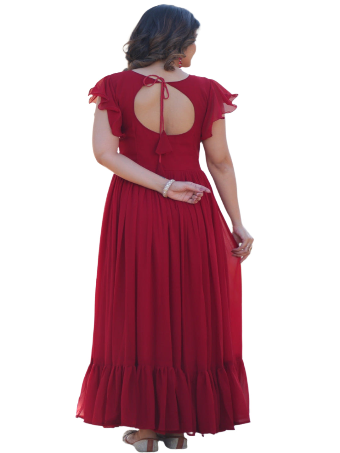 Woman in a red dress standing in a garden setting