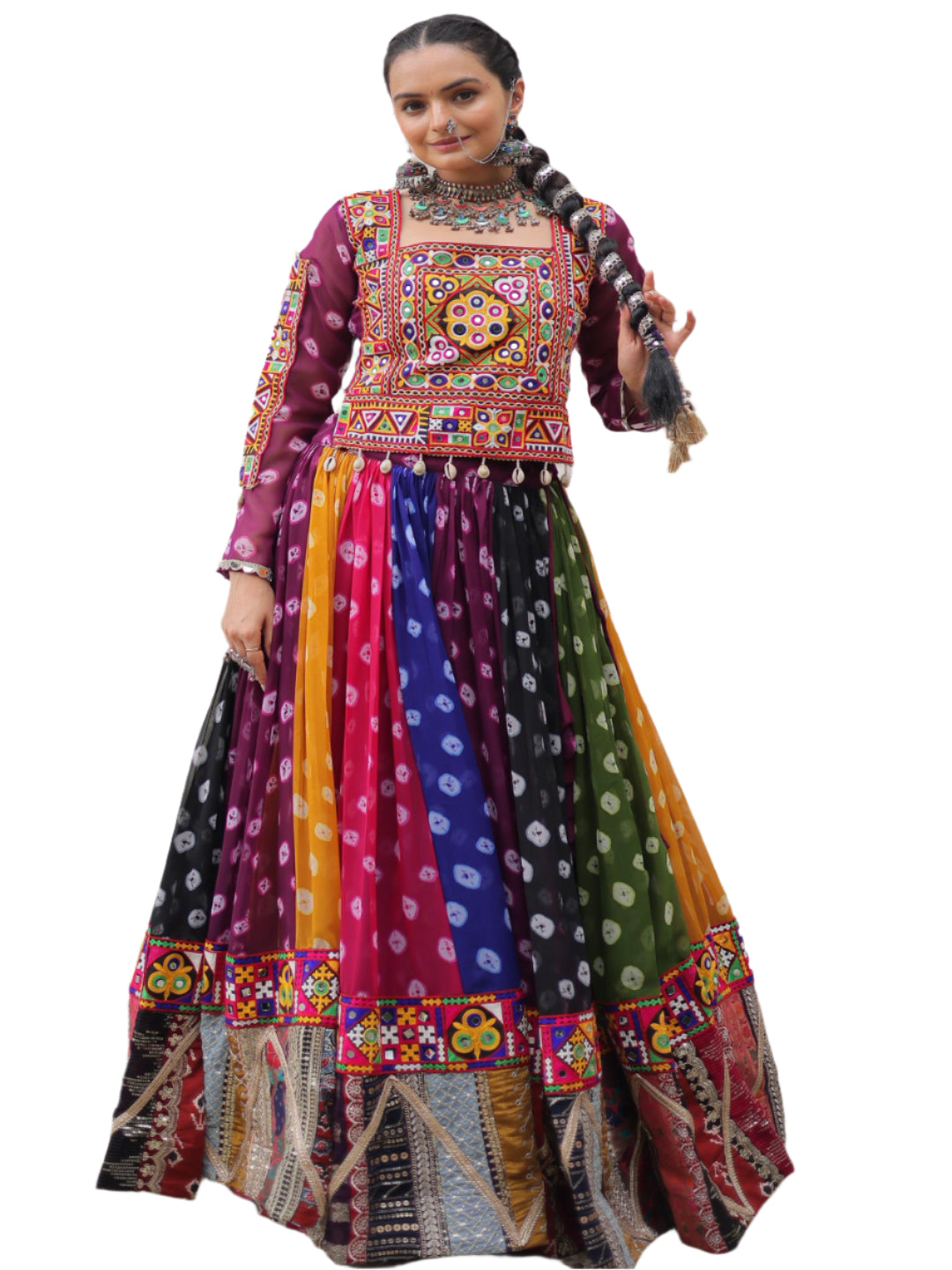 Woman in a colorful traditional outfit standing in front of a white building with arched windows.
