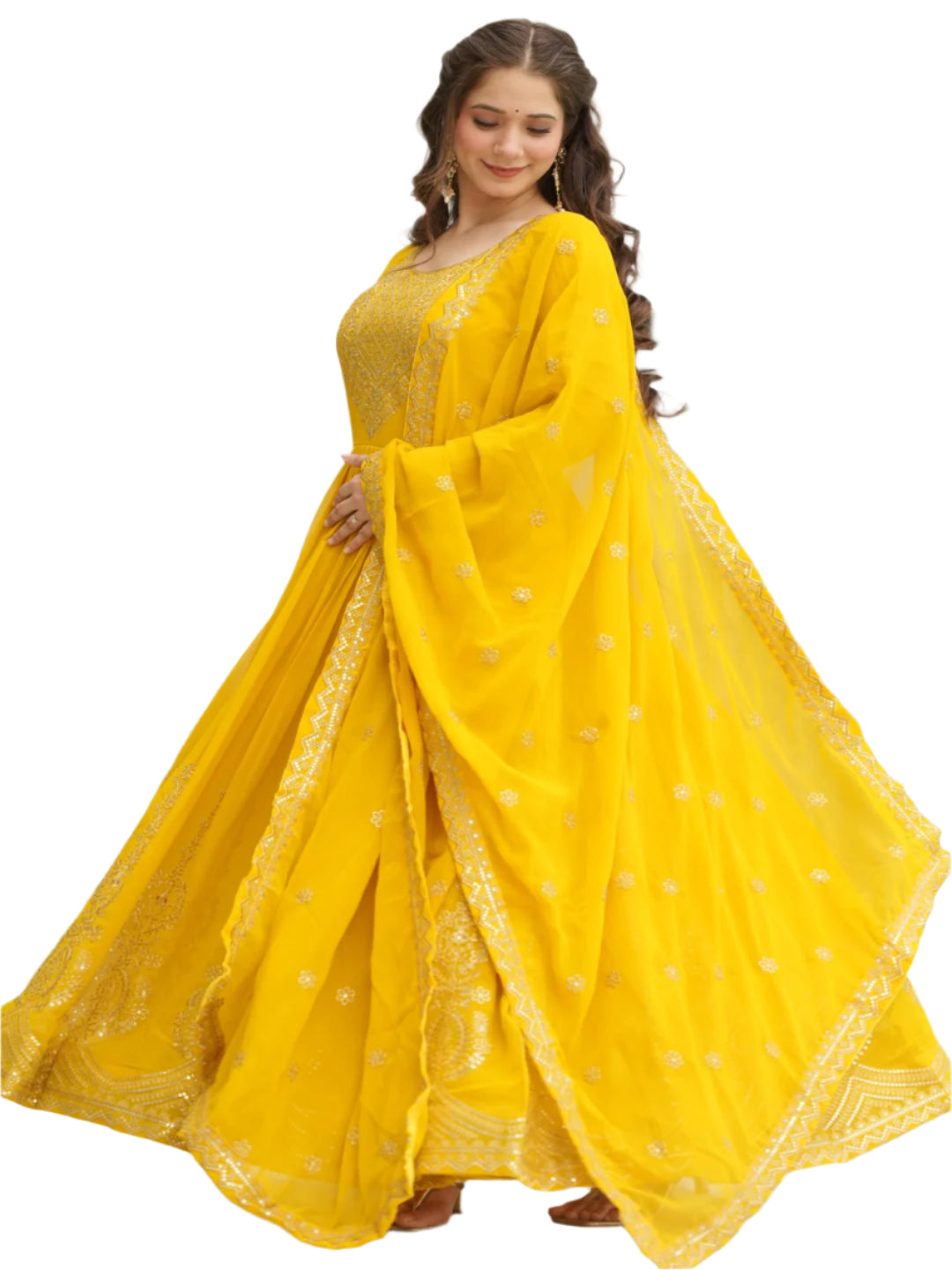 Woman in a yellow traditional outfit standing by a pool with greenery in the background