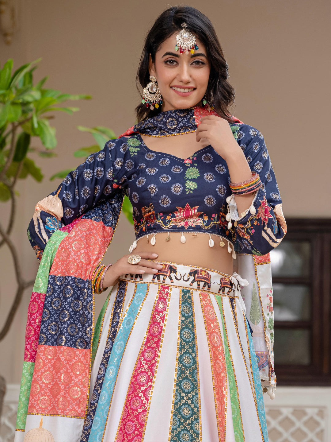 Woman wearing a traditional outfit with a colorful patterned top and skirt.