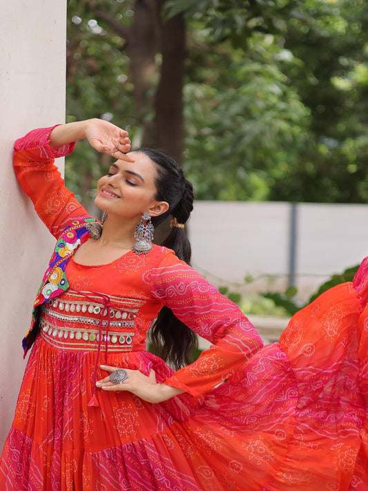 Woman in traditional red and pink outfit with floral patterns, standing outdoors.