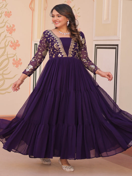 Woman wearing a purple gown with floral patterns in an indoor setting