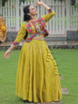 Woman in a colorful traditional outfit standing in a garden