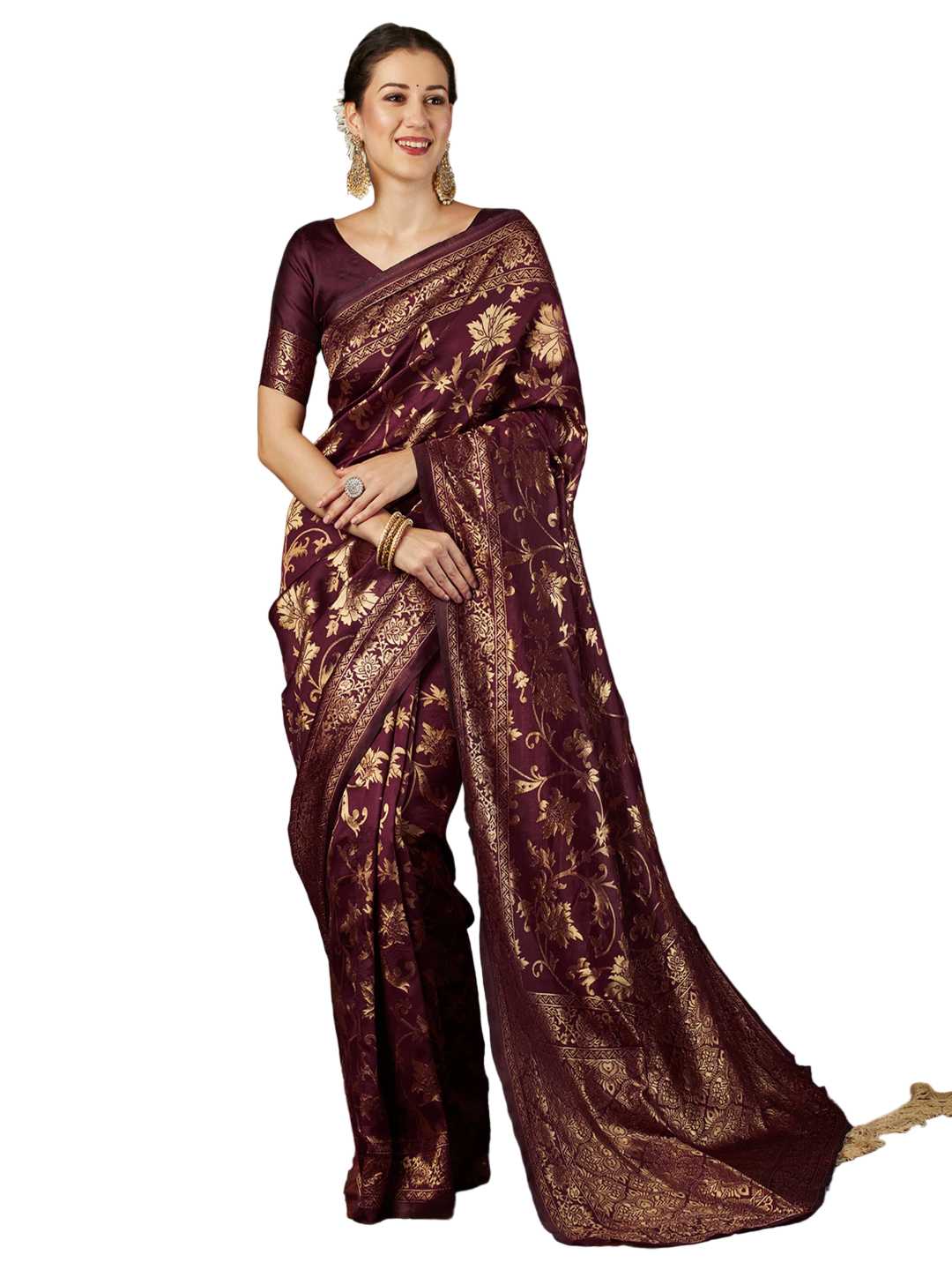 Woman wearing a maroon saree with gold patterns against a dark background