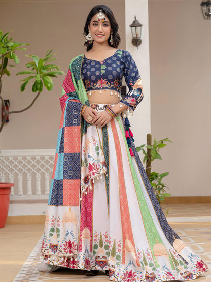 Woman in a colorful traditional outfit standing indoors with plants in the background