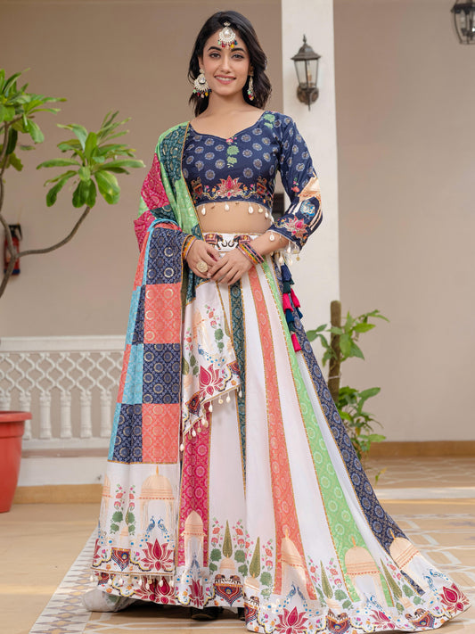Woman in a colorful traditional outfit standing indoors with plants in the background