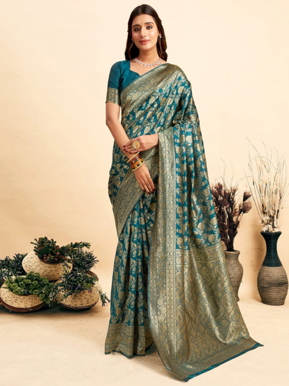 Woman wearing a green and blue saree with a neutral background