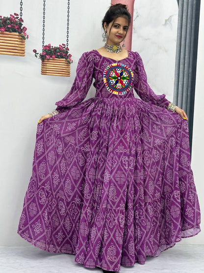 Woman wearing a purple traditional outfit with intricate patterns in a minimalistic setting.