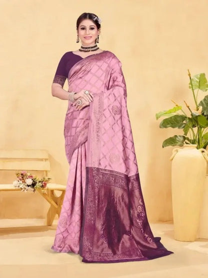 Woman wearing a pink and purple saree with a neutral background