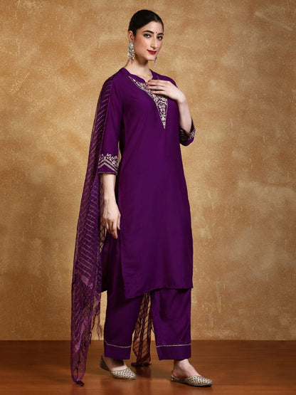 Woman wearing a purple traditional outfit with a brown background