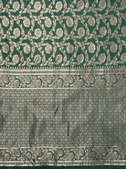 Green fabric with intricate white floral patterns