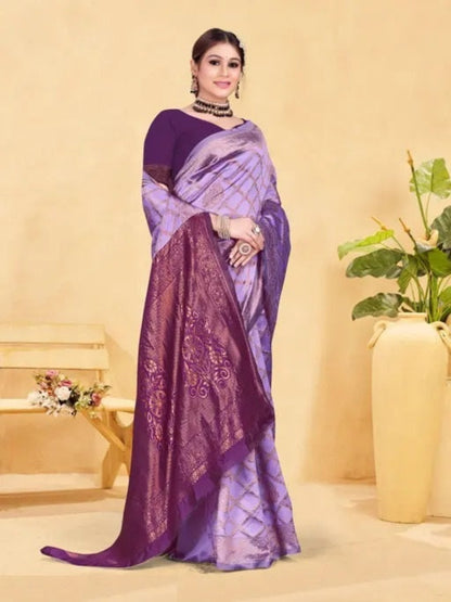 Woman wearing a purple saree with a plant and vase in the background