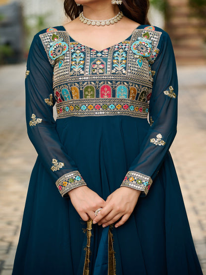 Navy blue dress with colorful embroidery and a necklace.