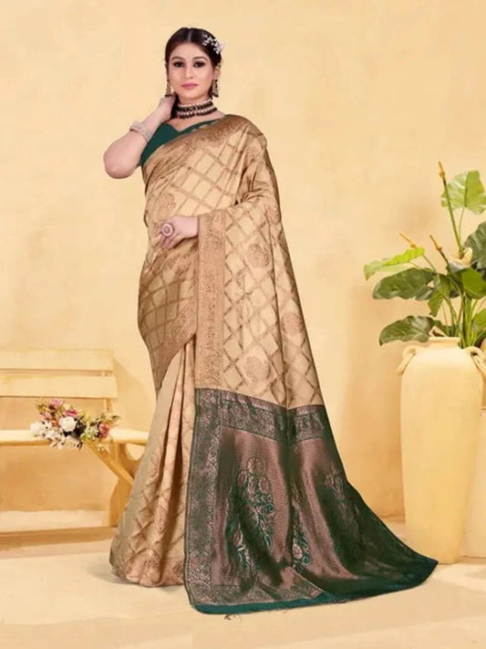 Woman wearing a beige and green saree with a neutral background