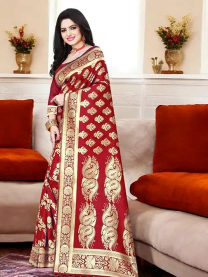 Woman wearing a red saree with gold patterns in a living room setting.